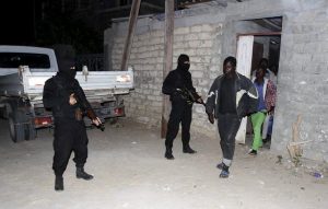 Armed members of the Libyan security forces watch during a raid on illegal migrants at a hideout in Tripoli, Libya, April 17, 2016. REUTERS/Hani Amara